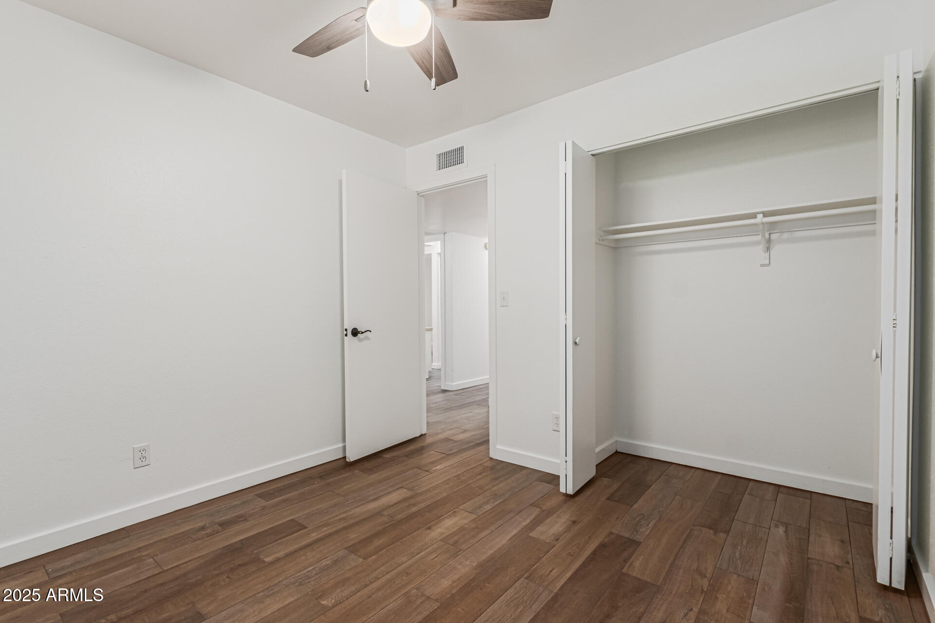 14034 North 60th Street Scottsdale, AZ 85254 - Photo 26 of 44 a view of an empty room with wooden floor