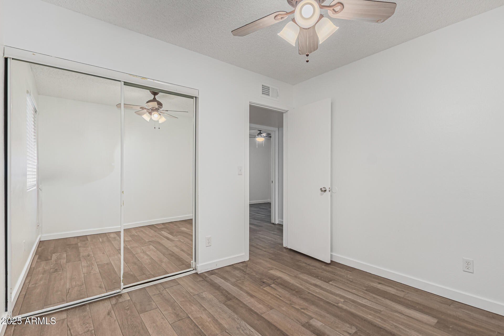 14034 North 60th Street Scottsdale, AZ 85254 - Photo 28 of 44 an empty room with wooden floor fan and windows