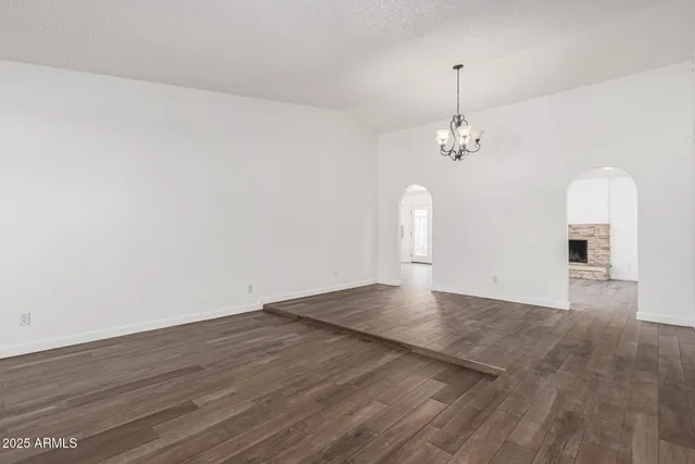 a view of a room with wooden floor and chandelier