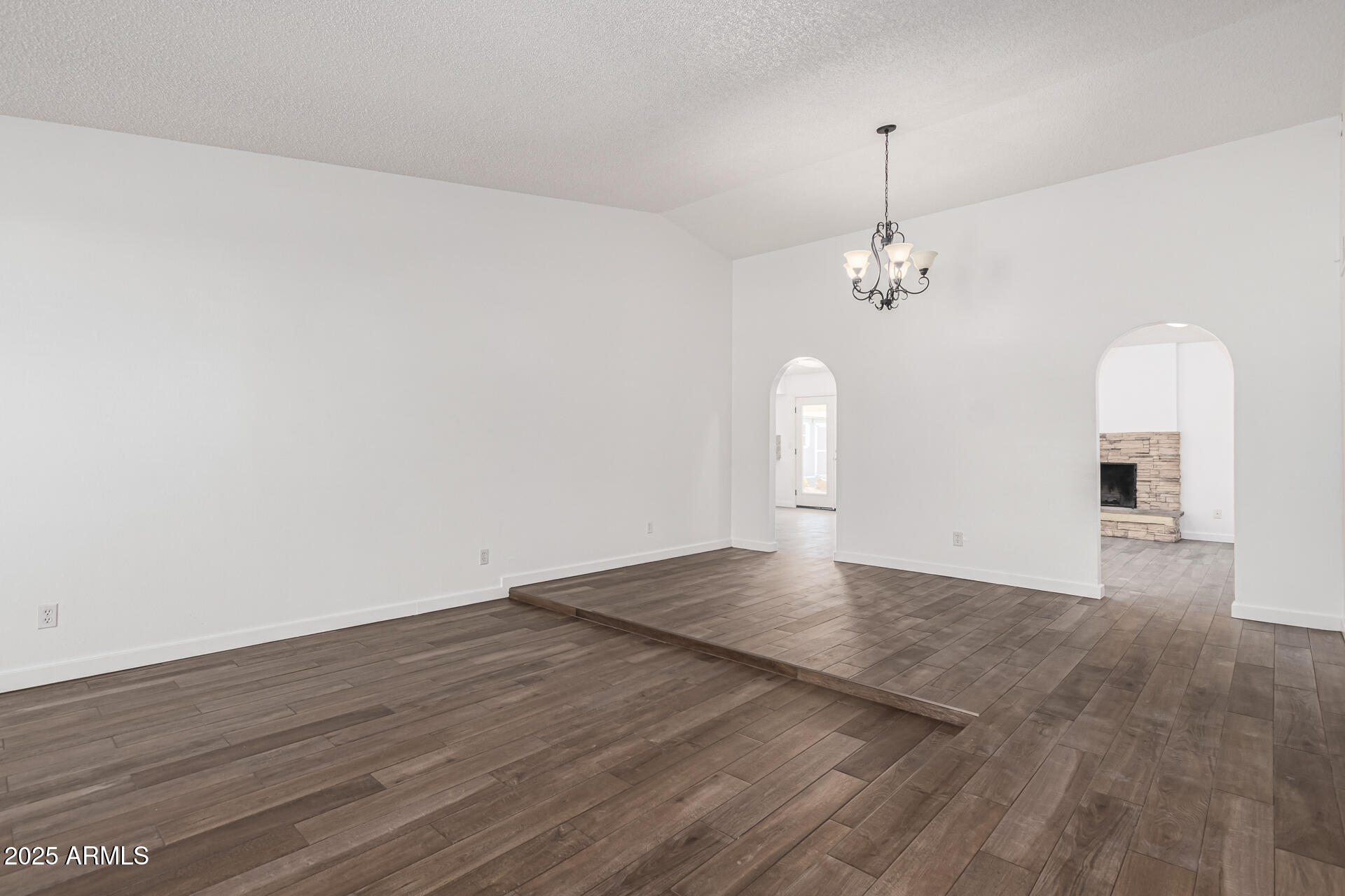 14034 North 60th Street Scottsdale, AZ 85254 - Photo 9 of 44 a view of a room with wooden floor and chandelier