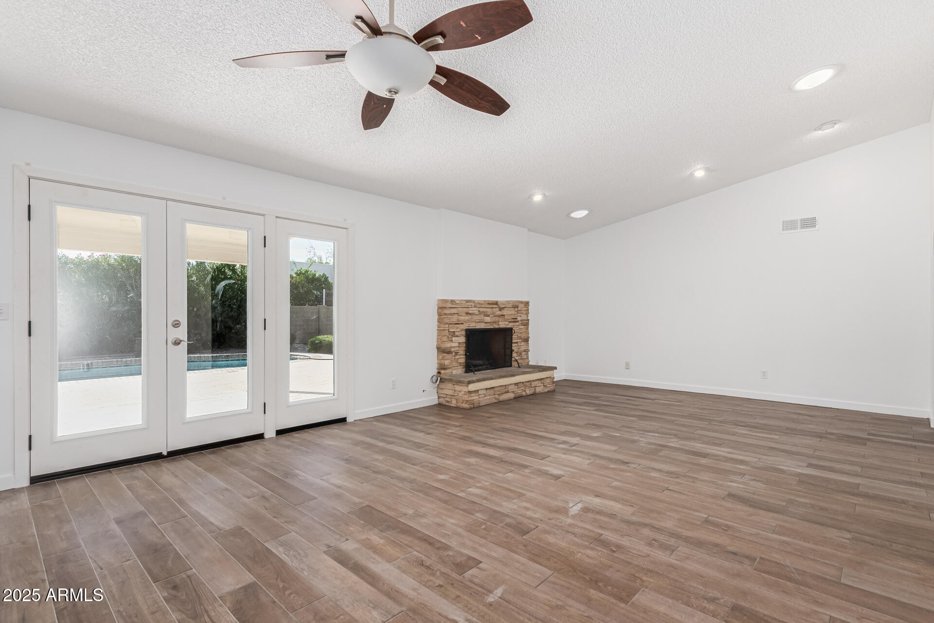 14034 North 60th Street Scottsdale, AZ 85254 - Photo 10 of 44 a view of an empty room with wooden floor and a window