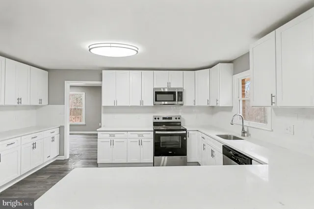 an empty room with windows and closet