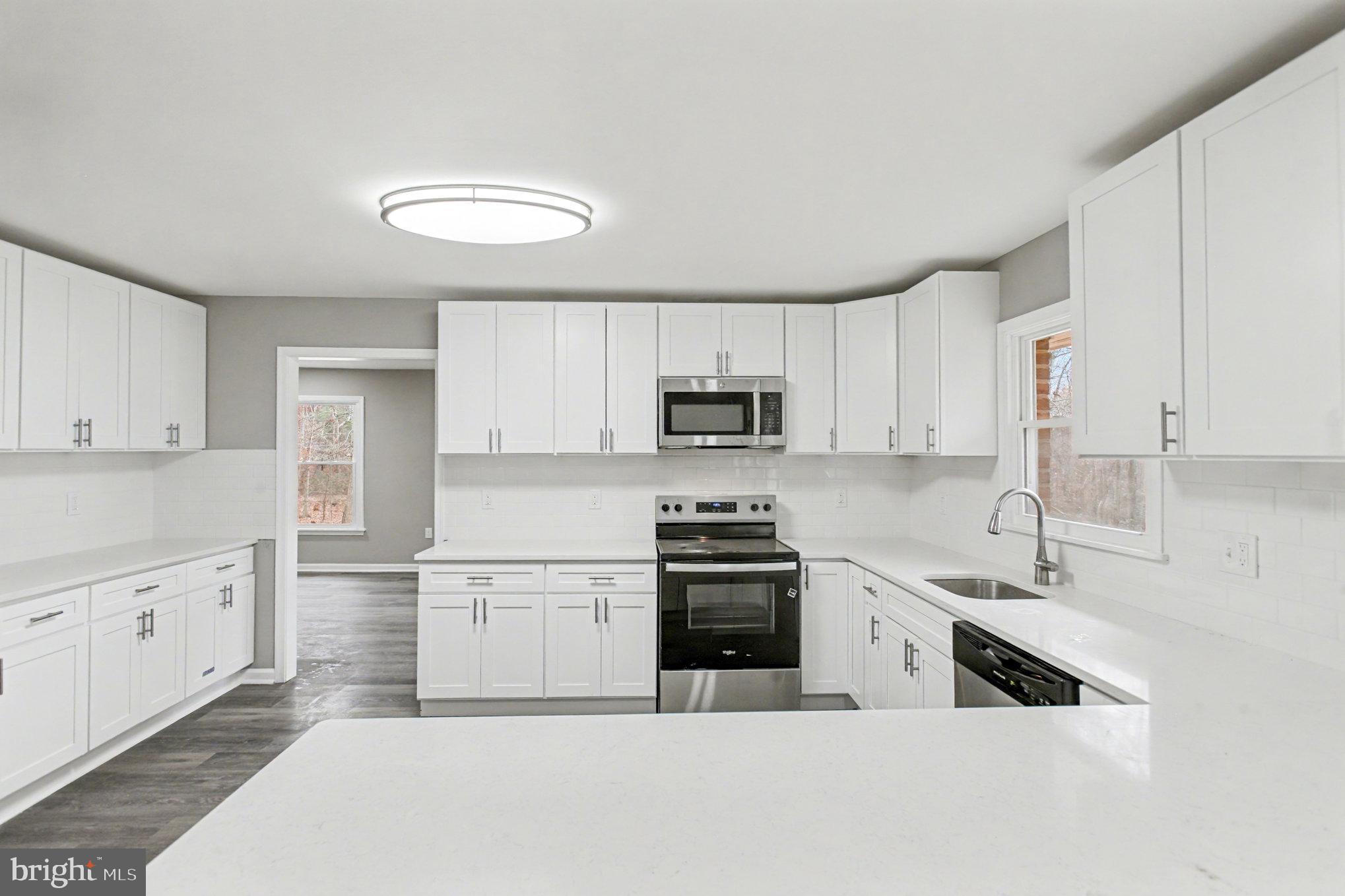 Garrett Court Elkton, MD 21921 - Photo 20 of 51 a kitchen with granite countertop a sink stainless steel appliances and white cabinets