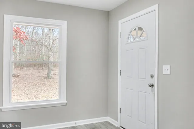 a view of room with stairs and fan