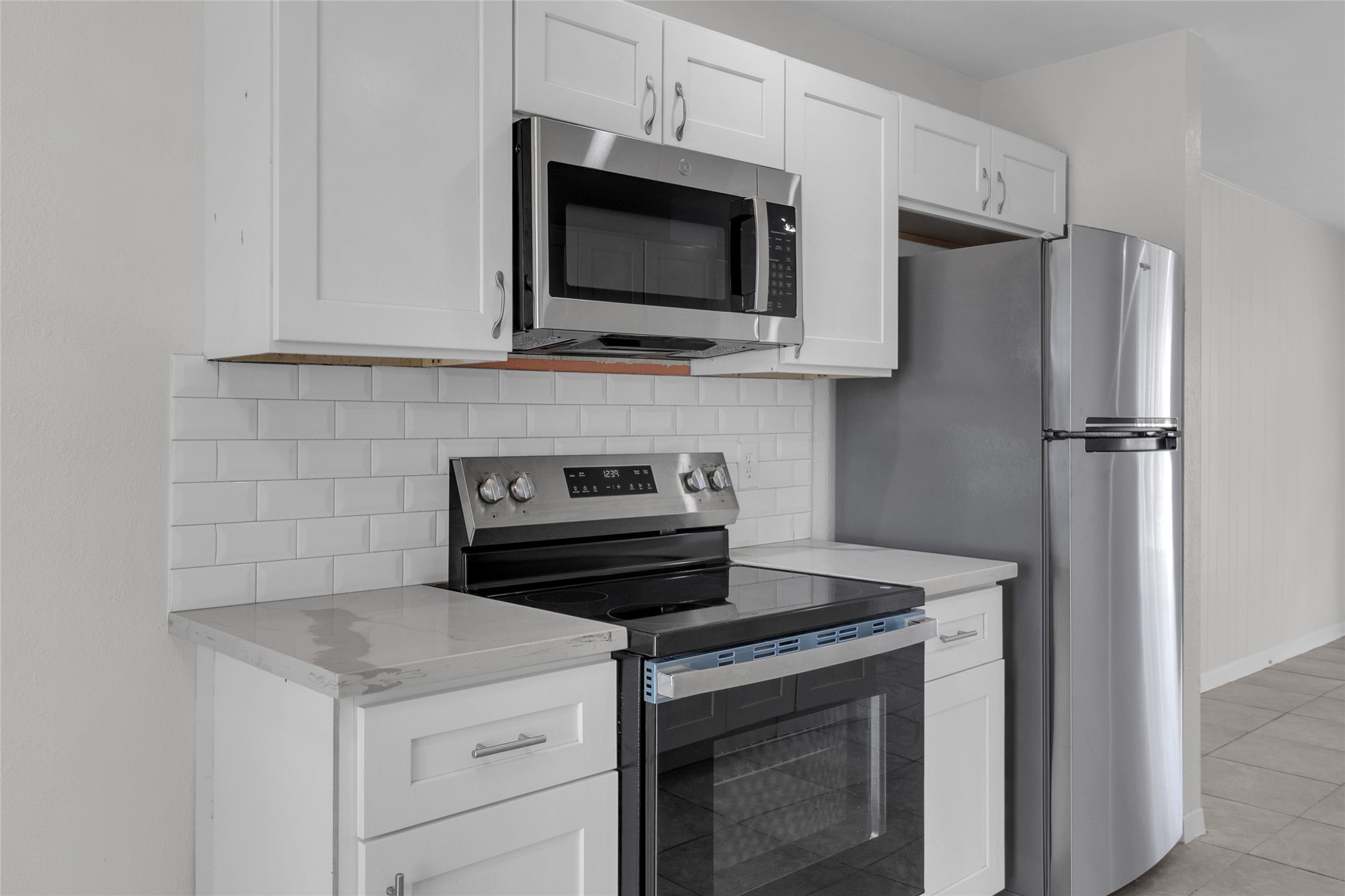 7622 Williams Street Houston, TX 77040 - Photo 11 of 42 a kitchen with a stove and a microwave