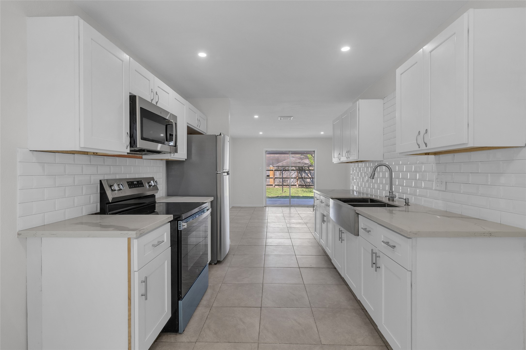 7622 Williams Street Houston, TX 77040 - Photo 13 of 42 a large kitchen with a stove top oven