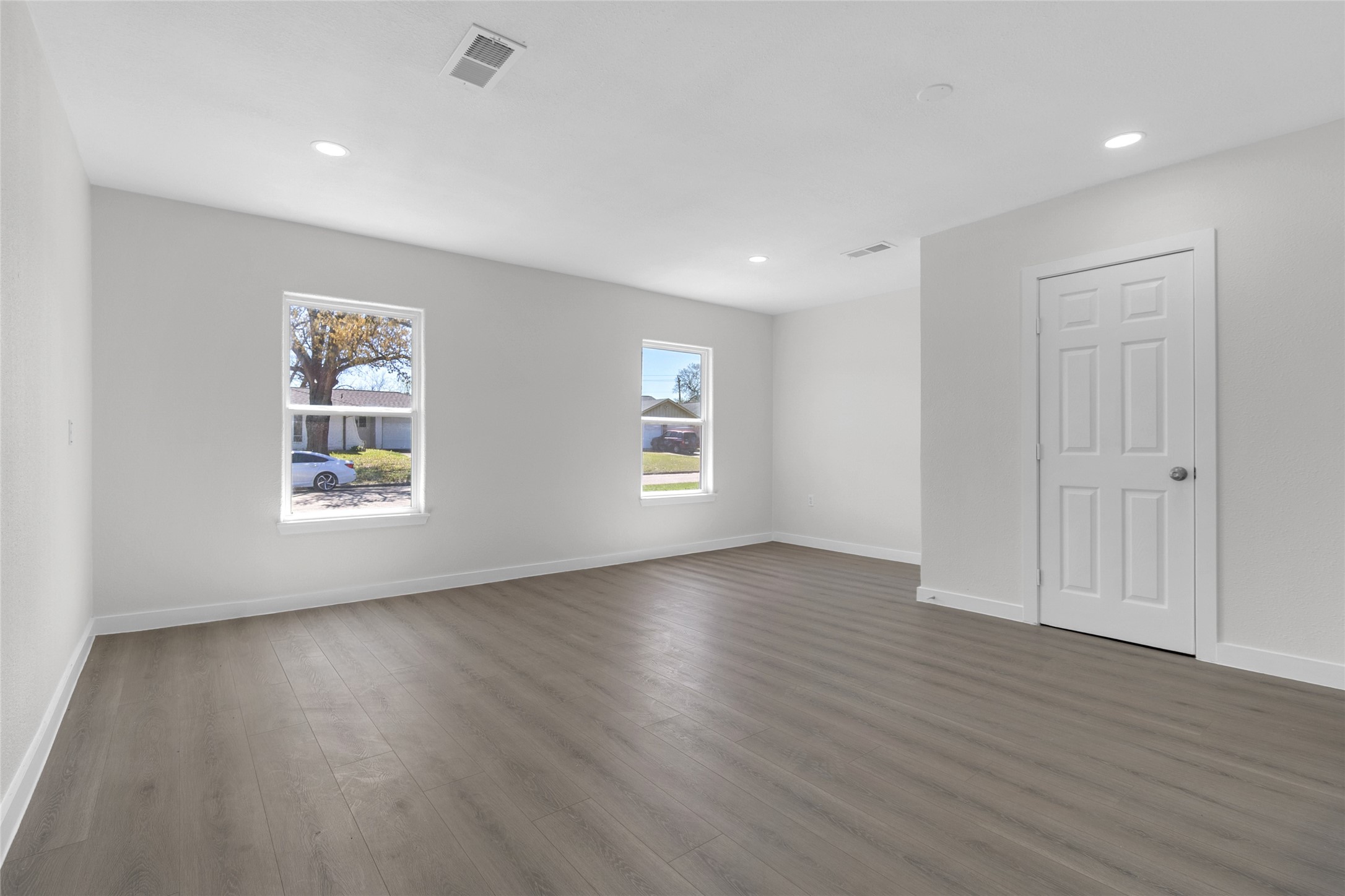 7622 Williams Street Houston, TX 77040 - Photo 14 of 42 a view of an empty room with wooden floor and a window