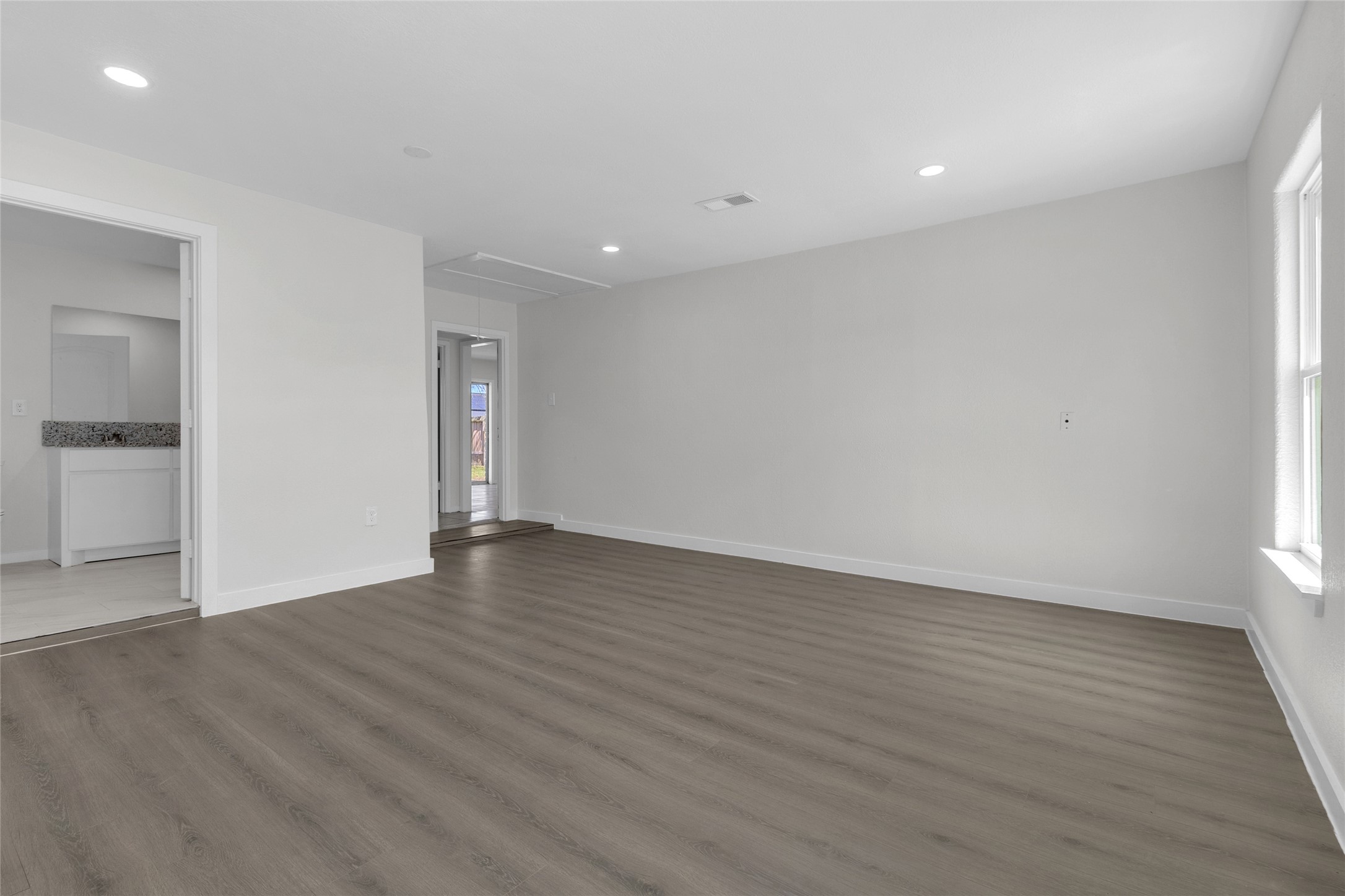 7622 Williams Street Houston, TX 77040 - Photo 16 of 42 a view of an empty room with wooden floor