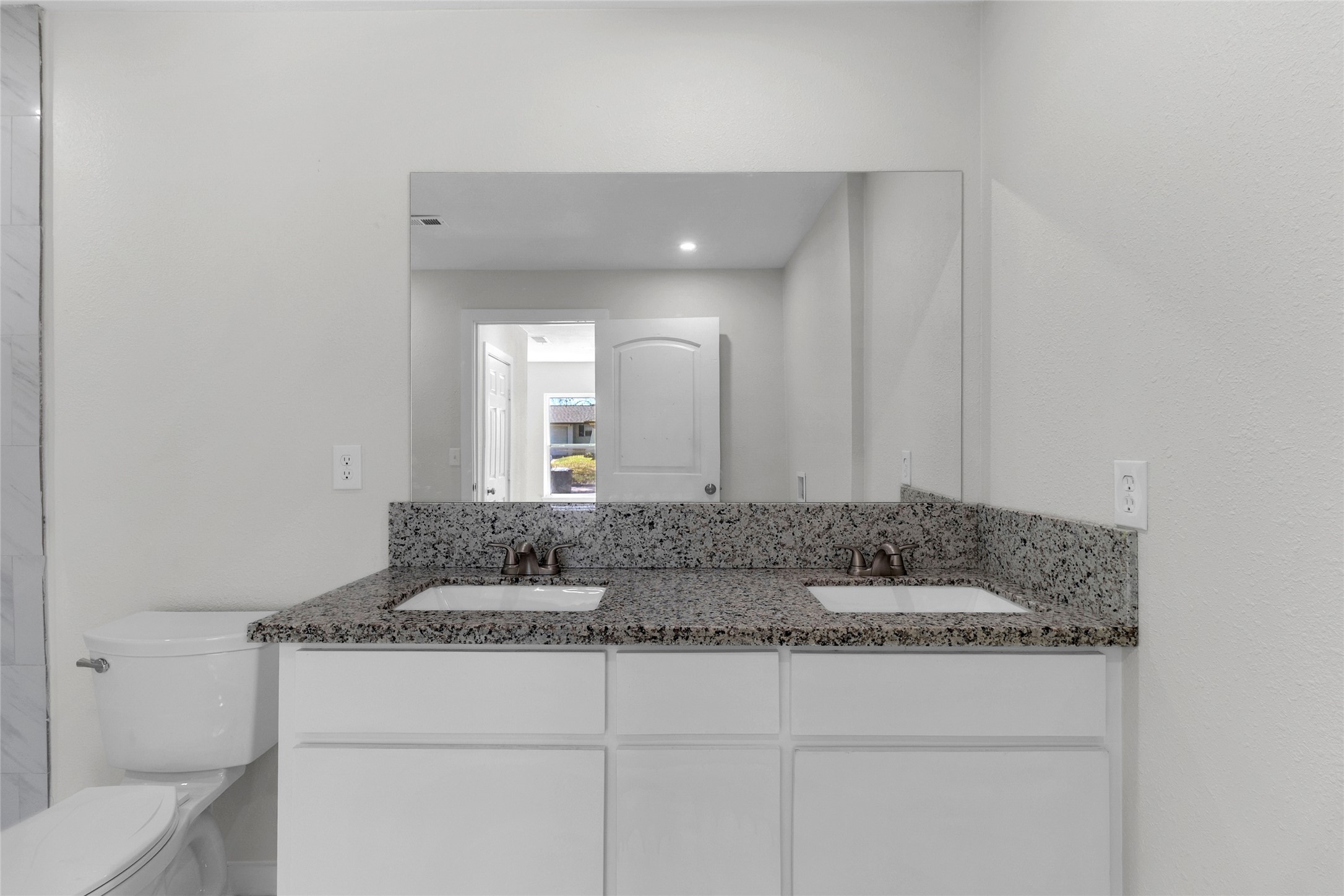 7622 Williams Street Houston, TX 77040 - Photo 20 of 42 a bathroom with a granite countertop sink and a mirror