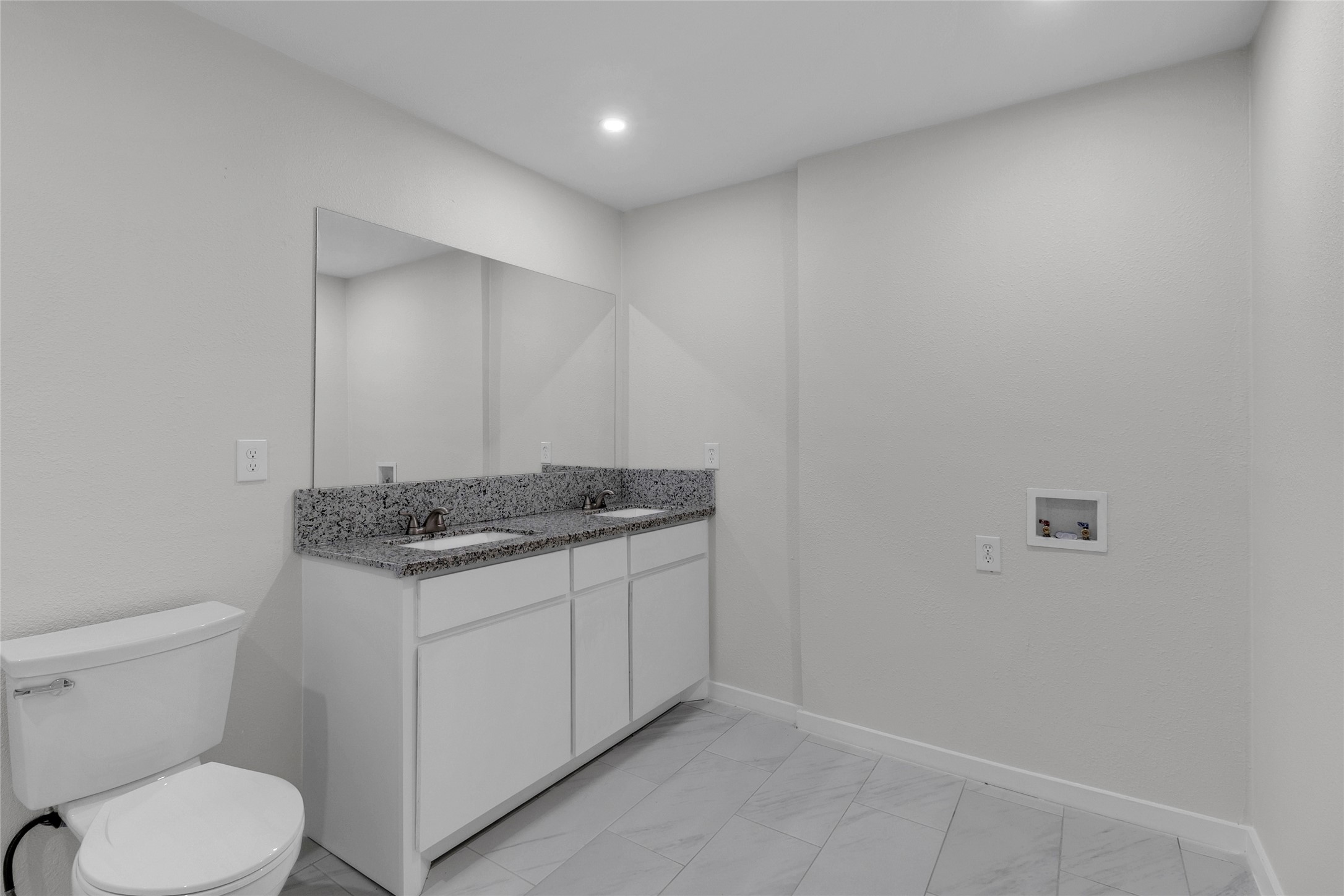 7622 Williams Street Houston, TX 77040 - Photo 21 of 42 a bathroom with a granite countertop toilet and a sink