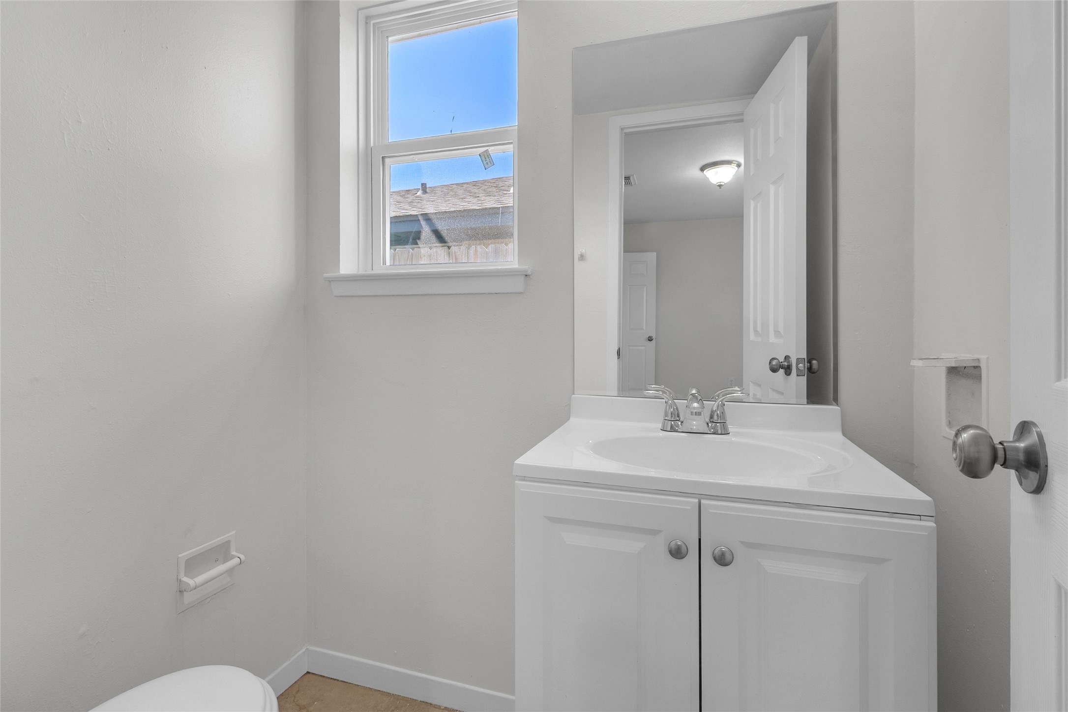 7622 Williams Street Houston, TX 77040 - Photo 25 of 42 a bathroom with a sink mirror vanity and toilet