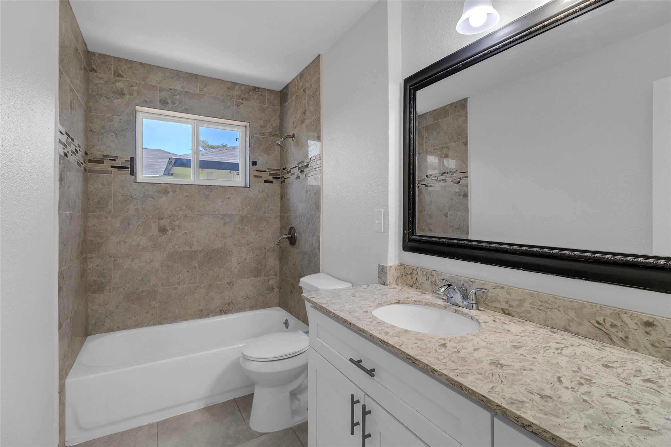 7622 Williams Street Houston, TX 77040 - Photo 28 of 42 a bathroom with a granite countertop sink a toilet and bathtub