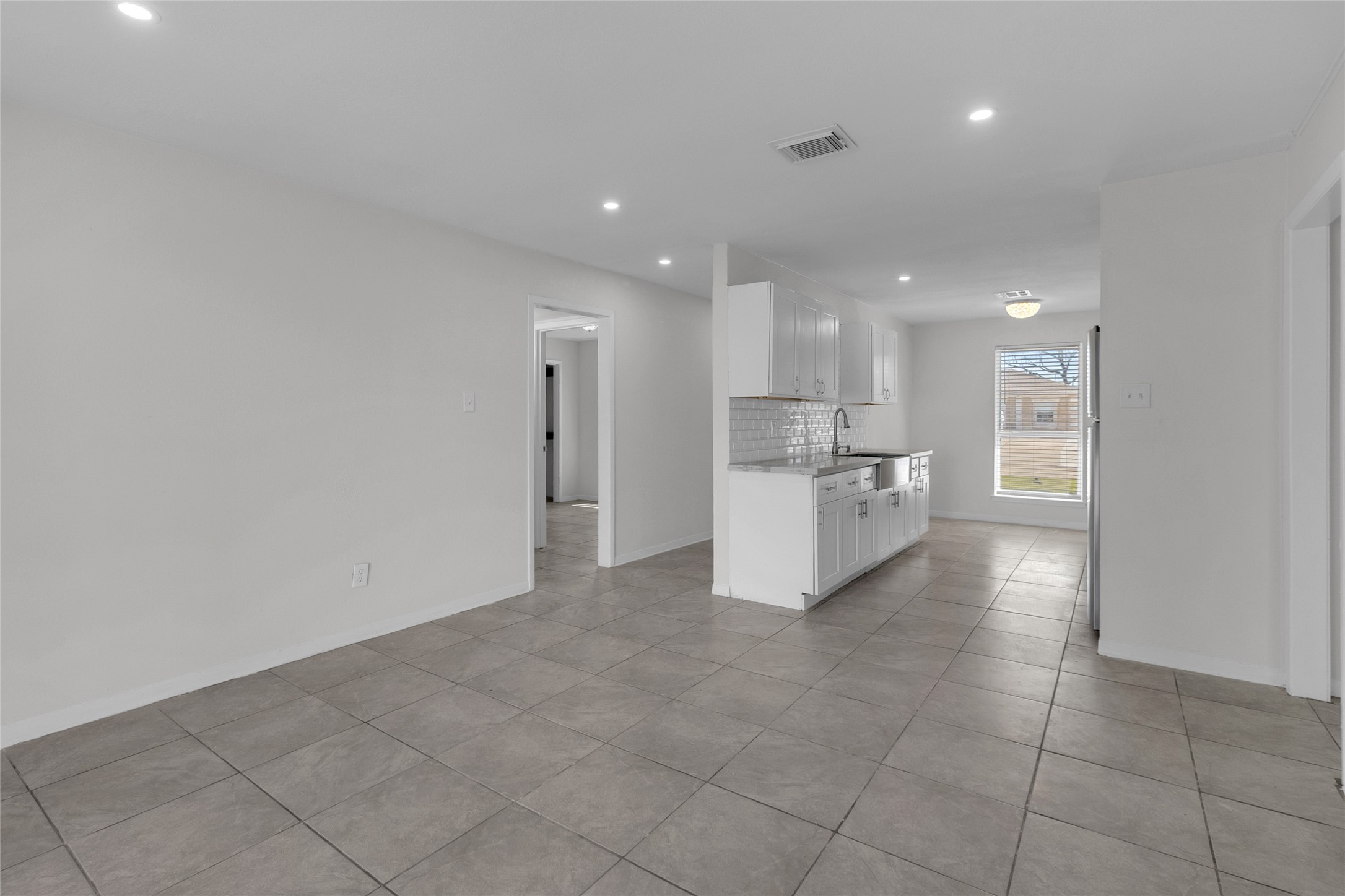 7622 Williams Street Houston, TX 77040 - Photo 6 of 42 a view of a kitchen with a sink and an empty room