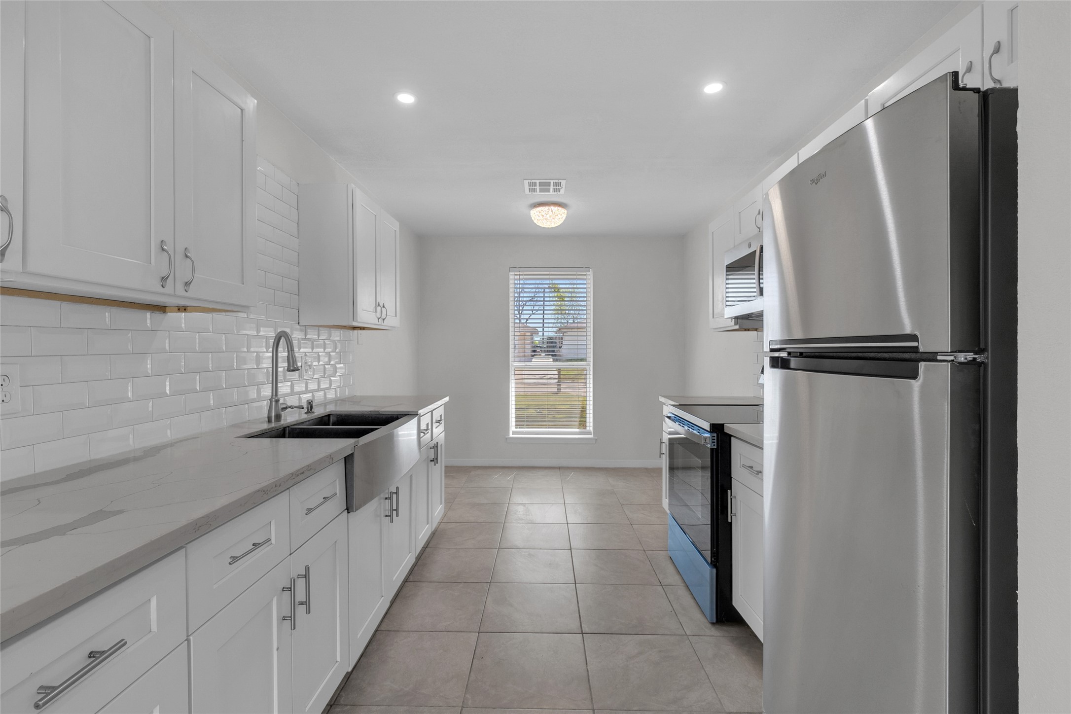 7622 Williams Street Houston, TX 77040 - Photo 8 of 42 a kitchen with a refrigerator and a sink
