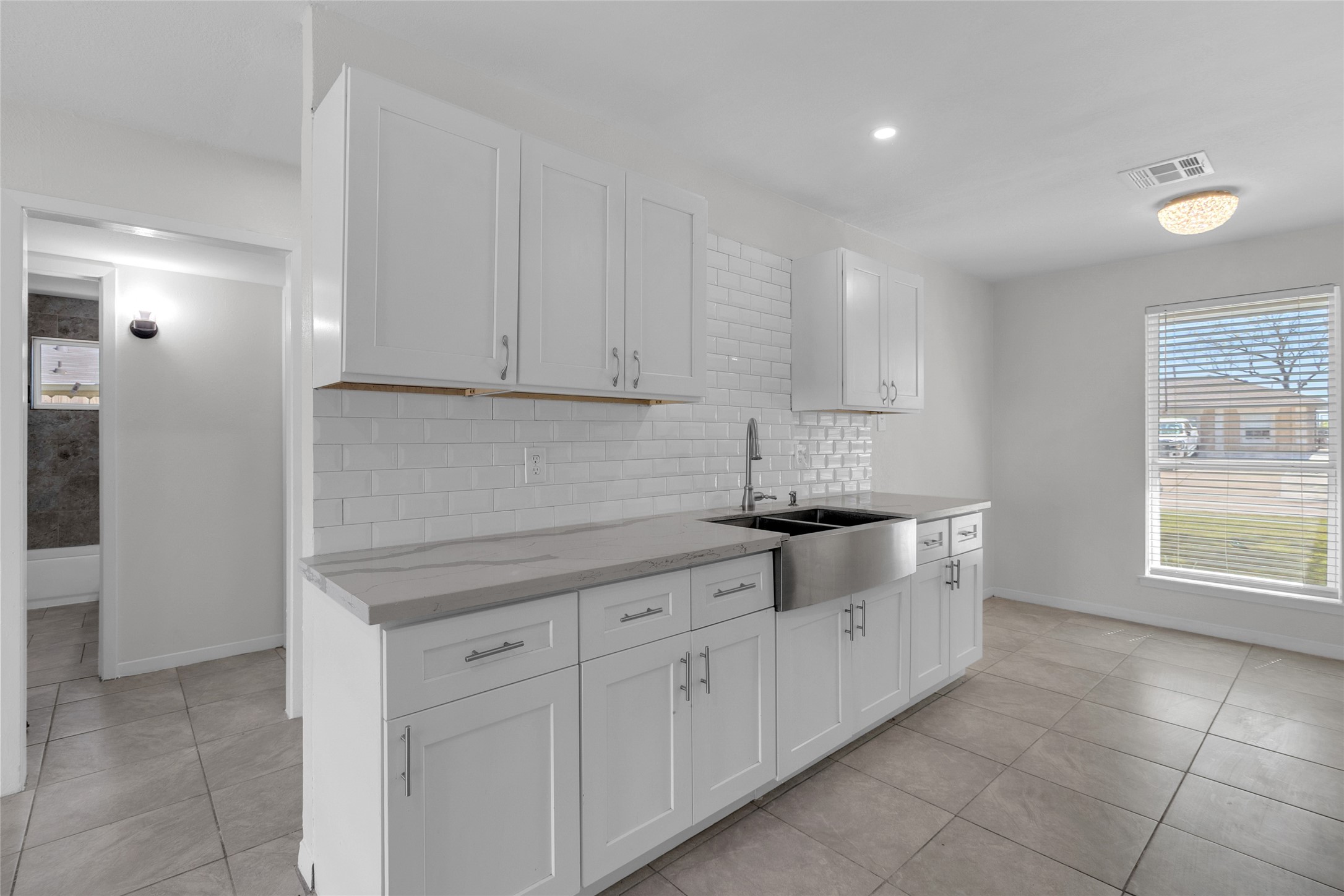 7622 Williams Street Houston, TX 77040 - Photo 9 of 42 a kitchen with granite countertop white cabinets and stainless steel appliances