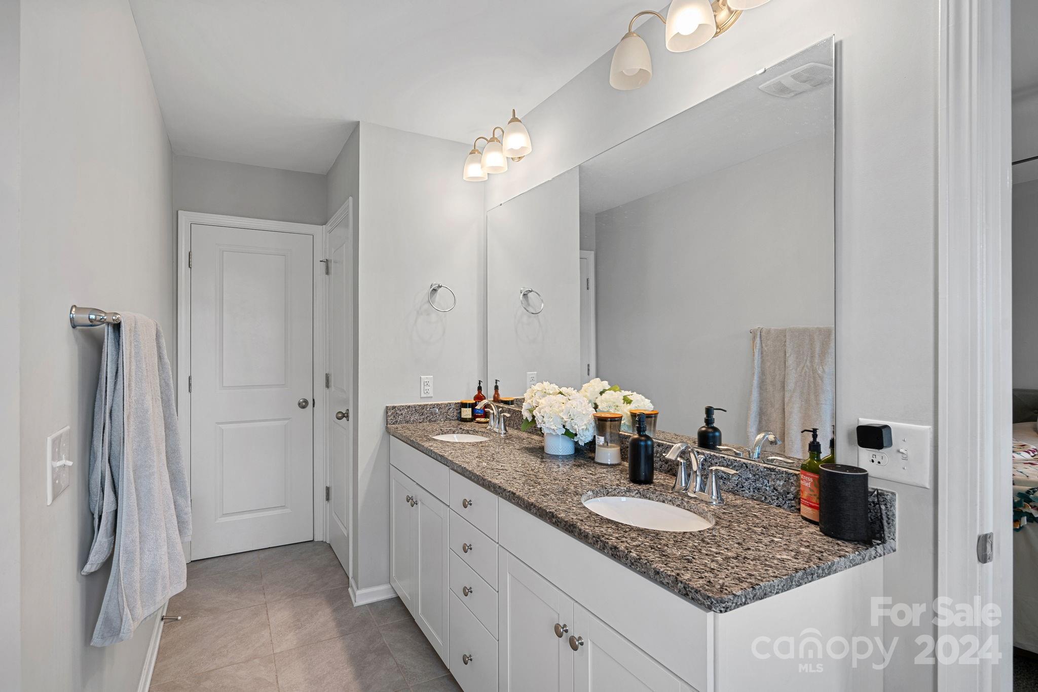 7044 Harris Bay Road Charlotte, NC 28269 - Photo 12 of 17 a bathroom with a granite countertop sink and a mirror