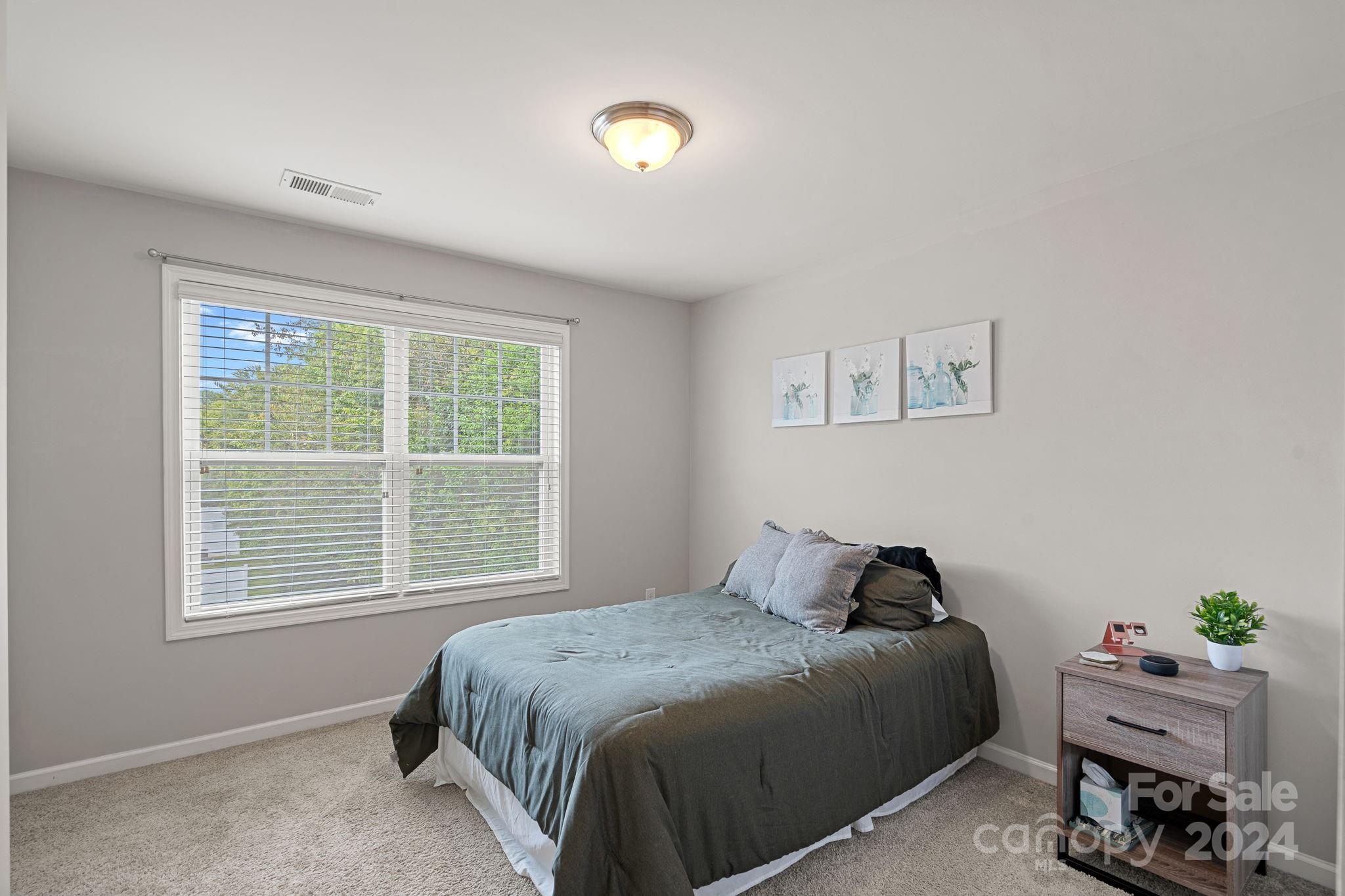 7044 Harris Bay Road Charlotte, NC 28269 - Photo 13 of 17 a bedroom with a bed and window
