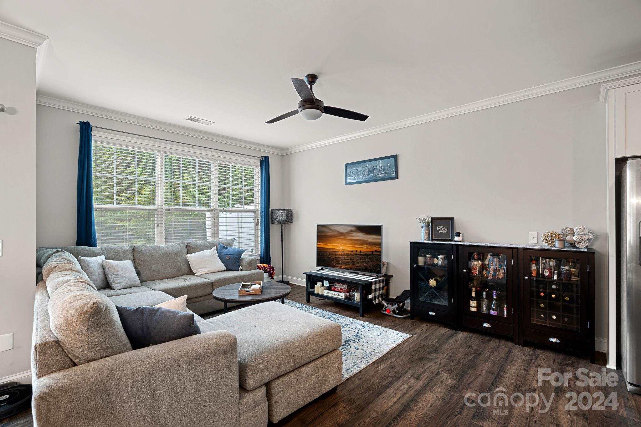 7044 Harris Bay Road Charlotte, NC 28269 - Photo 5 of 17 a living room with furniture and a flat screen tv