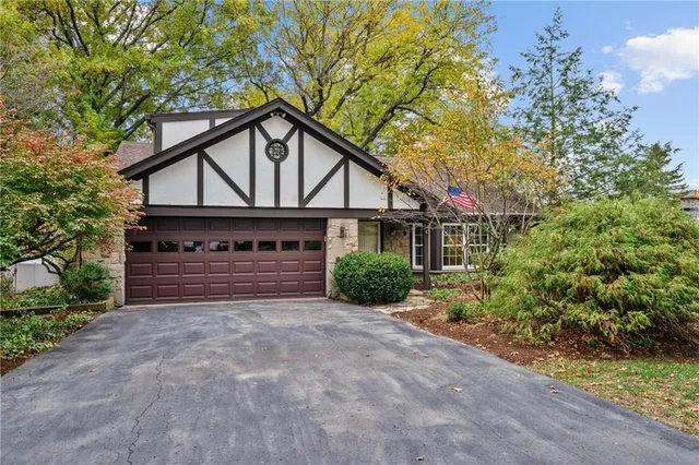 a view of a house with a yard and garage