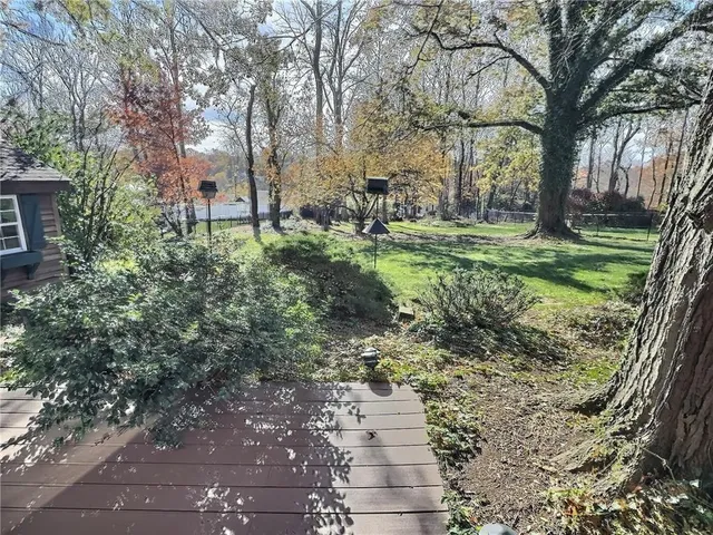 an aerial view of residential houses with outdoor space and street view