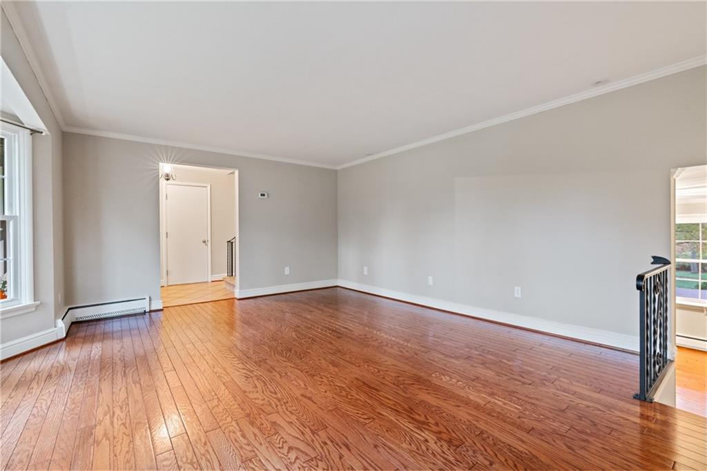 126 Rockingham Lane Canonsburg, PA 15317 - Photo 5 of 44 a view of an empty room with wooden floor and a window