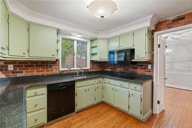 a kitchen with a sink stove and cabinets