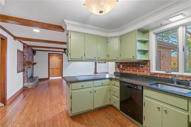 a kitchen with a sink and wooden cabinets
