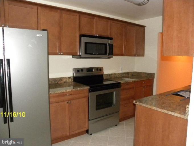 2724 2nd Street Southeast Washington, DC 20032 - Photo 3 of 4 a kitchen with a stove and a microwave