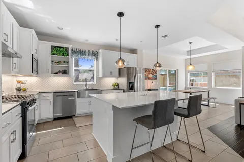 a kitchen with stainless steel appliances granite countertop a sink and cabinets