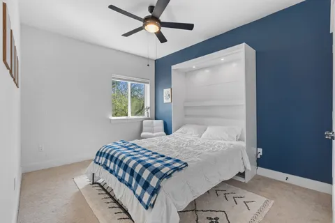 a bedroom with a bed and a window