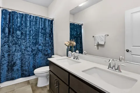 a bathroom with a sink a toilet and mirror