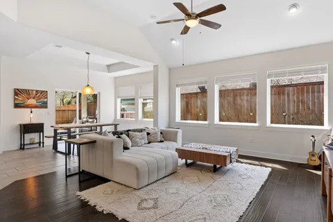 a living room with furniture and wooden floor