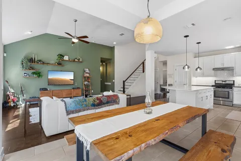 a living room with kitchen island furniture and a chandelier