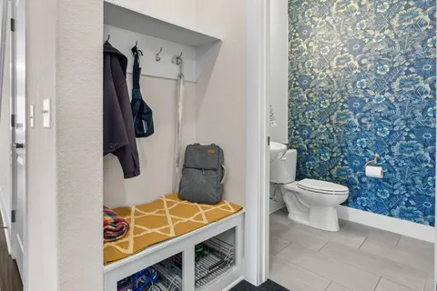 a bathroom with a toilet and a shower curtain