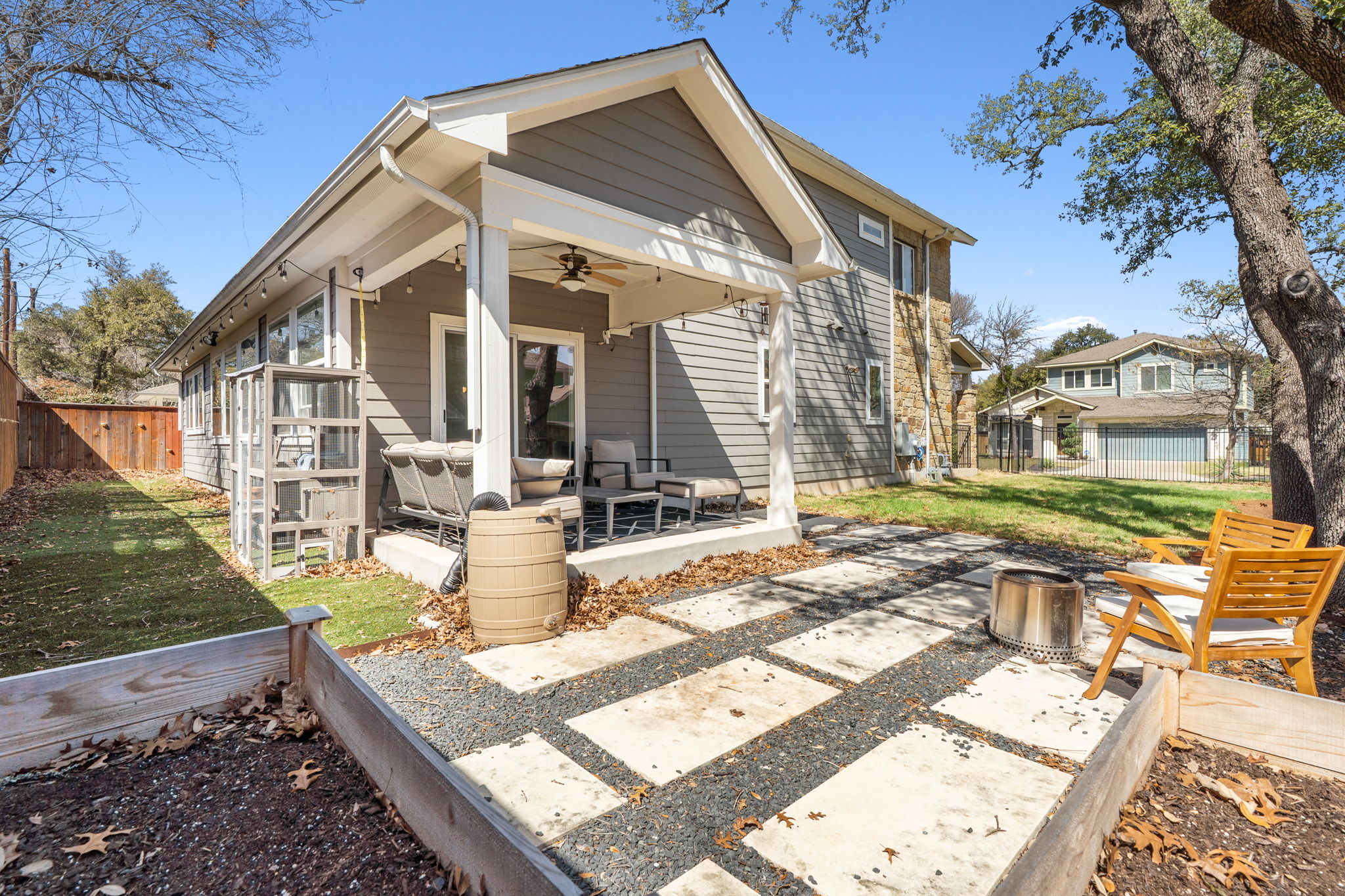 7205 Albert Road Austin, TX 78745 - Photo 22 of 24 The covered patio invites you to relax or entertain, while a paver extension with a firepit makes for cozy evenings under the Texas sky. A turf dog run make this a pet-friendly oasis.