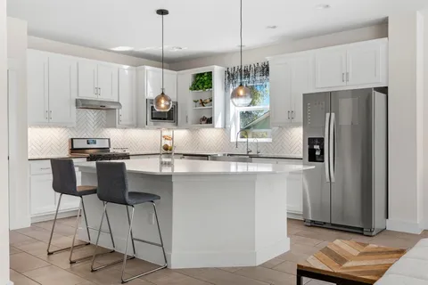 a kitchen with kitchen island granite countertop a counter space stainless steel appliances and cabinets