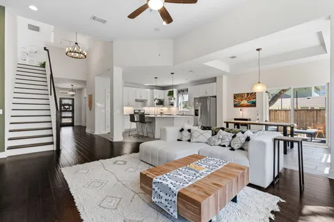 a living room with furniture and wooden floor