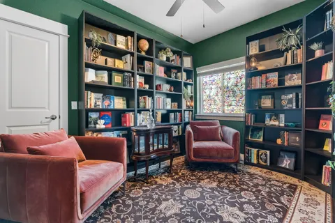 a living room with furniture and a book shelf