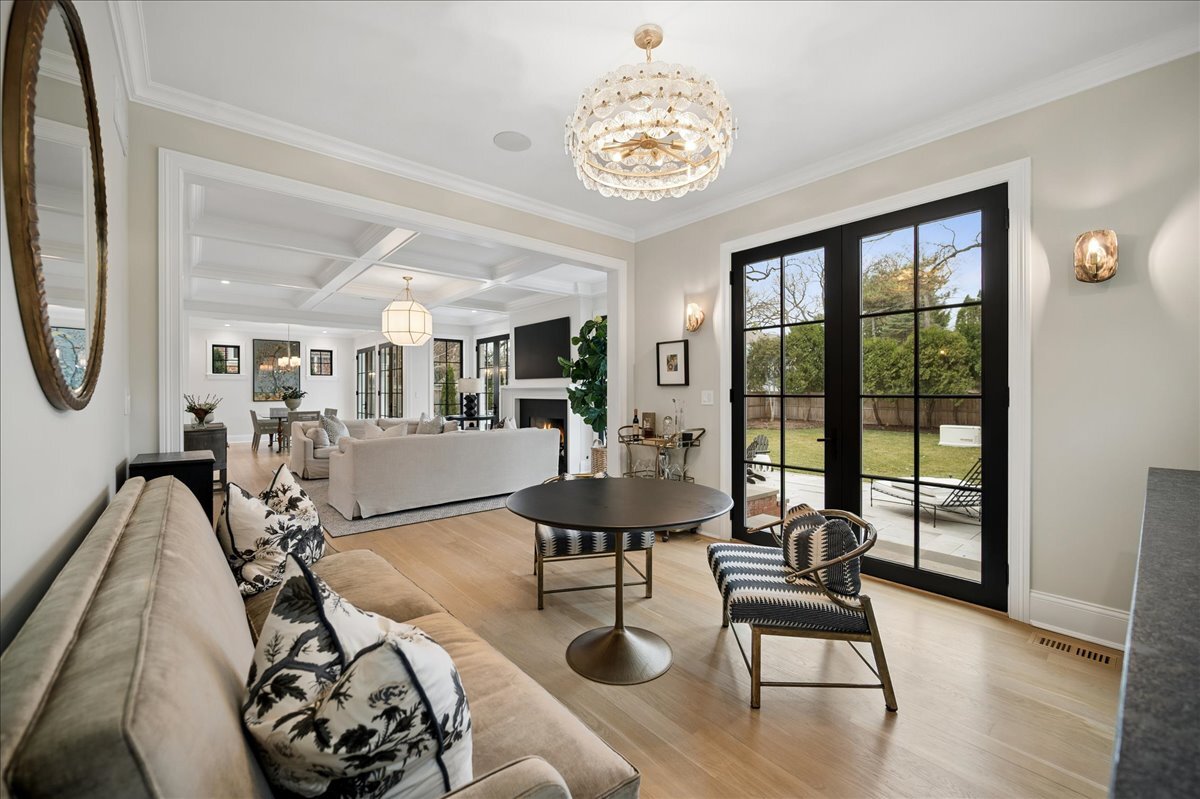 525 Ash Street Winnetka, IL 60093 - Photo 11 of 56 a view of a livingroom and dining room with furniture wooden floor and a chandelier