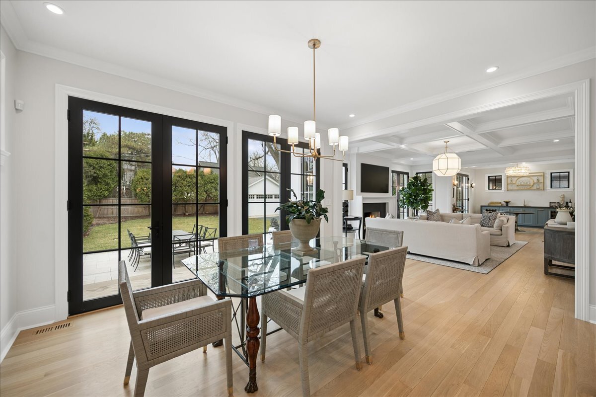 525 Ash Street Winnetka, IL 60093 - Photo 12 of 56 a view of a dining room and livingroom with furniture wooden floor a chandelier