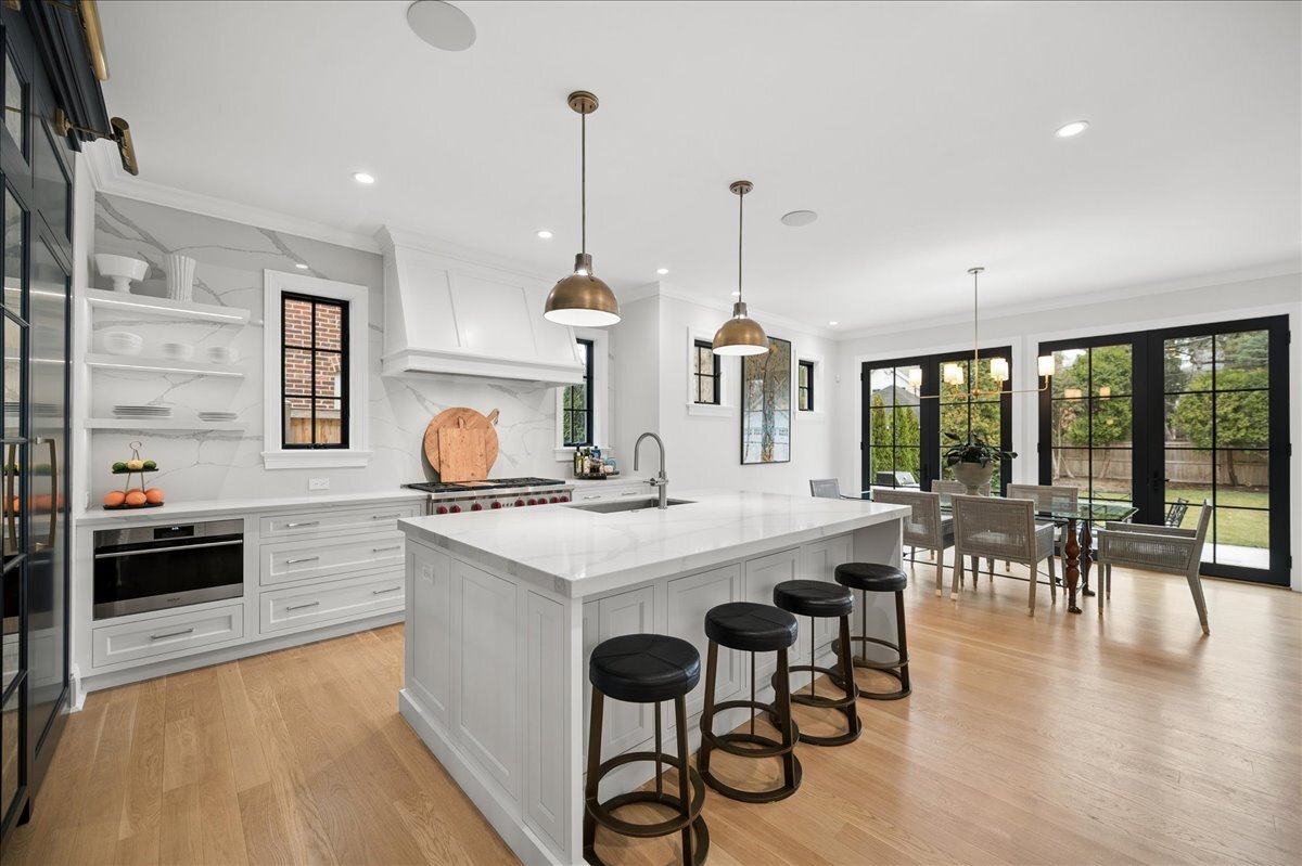 525 Ash Street Winnetka, IL 60093 - Photo 14 of 56 a kitchen with stainless steel appliances granite countertop a stove and chairs with wooden floor