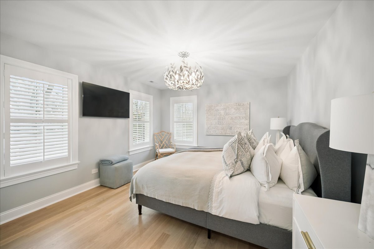 525 Ash Street Winnetka, IL 60093 - Photo 26 of 56 a bedroom with a large bed and a flat tv screen on a dresser