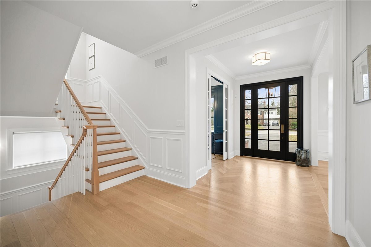 525 Ash Street Winnetka, IL 60093 - Photo 3 of 56 a view of an empty room with wooden floor and stairs