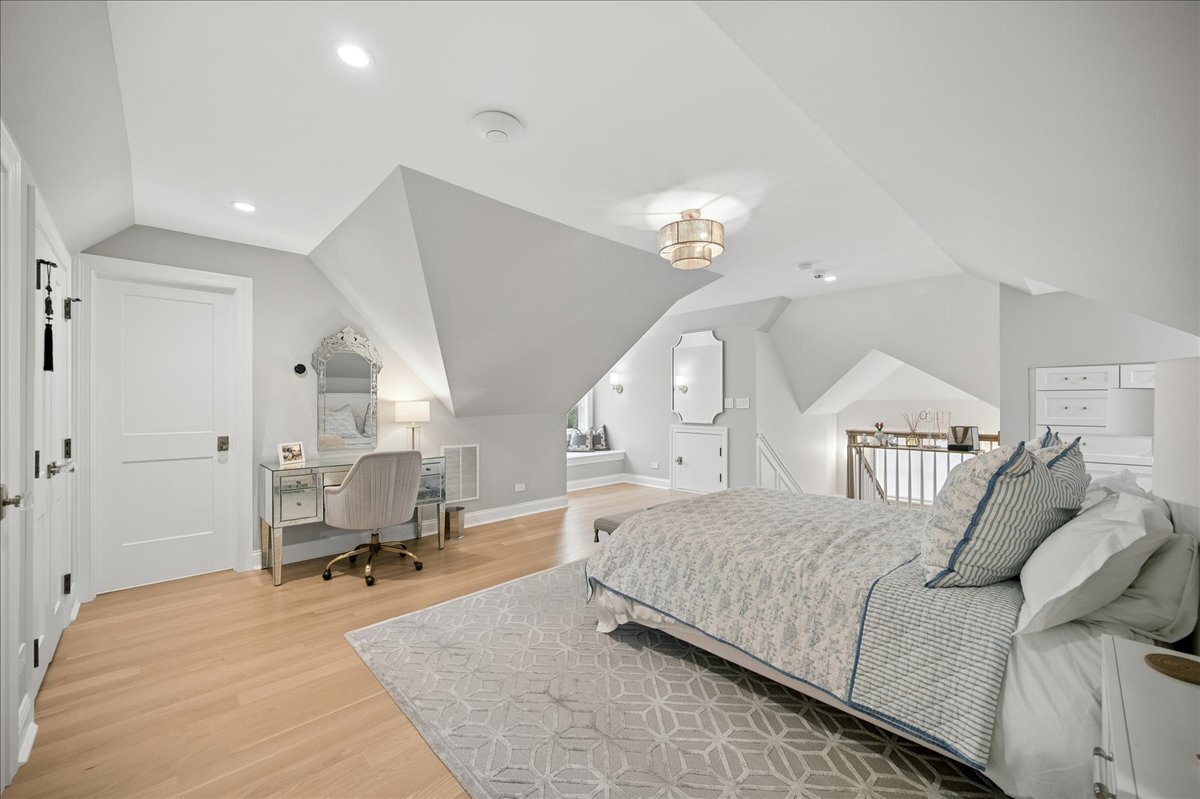525 Ash Street Winnetka, IL 60093 - Photo 41 of 56 a bedroom with a large bed and a chandelier