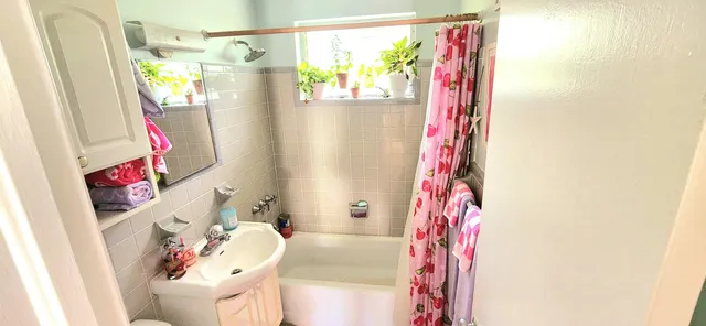 a bathroom with a bathtub and shower curtain