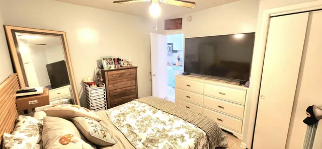 a bedroom with a bed and flat screen tv