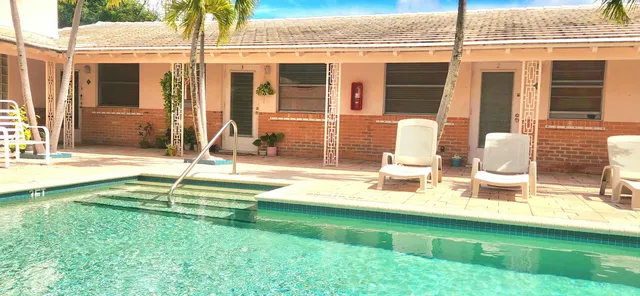 a view of backyard with a swimming pool and furniture