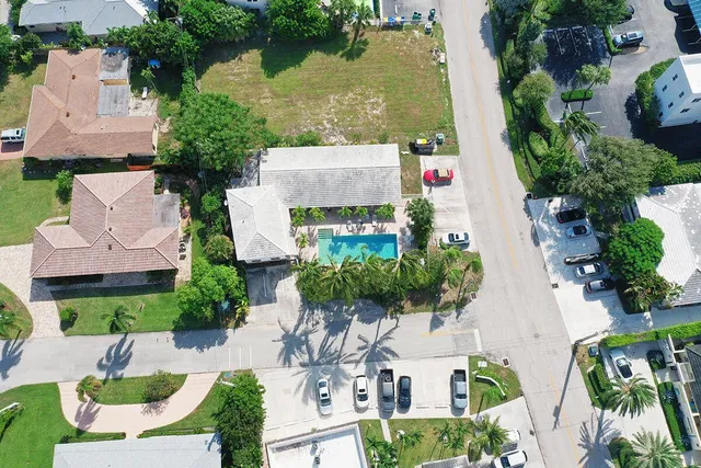 an aerial view of house with yard swimming pool and outdoor seating