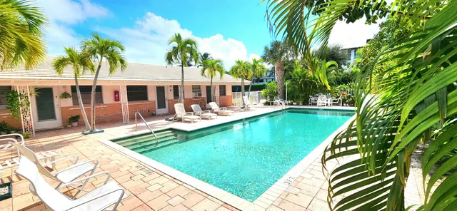 a view of a house with swimming pool and sitting area
