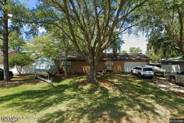 a view of a house with backyard porch and sitting area